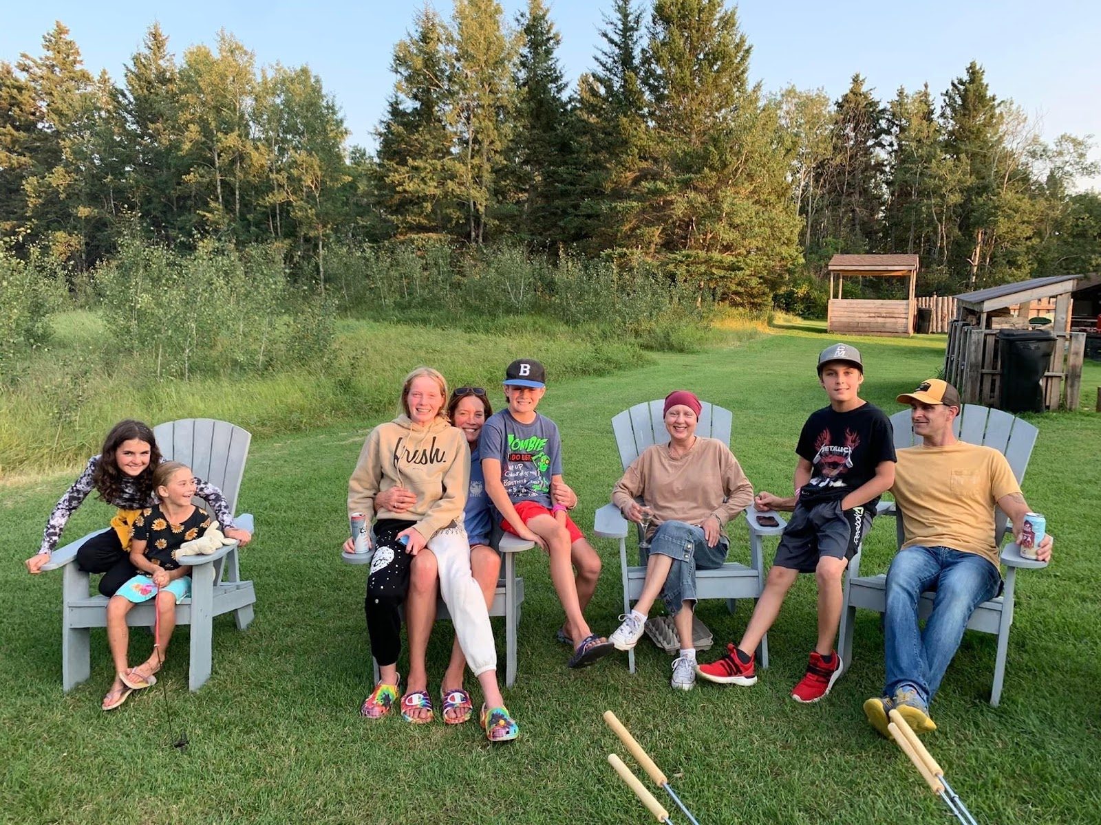 Family relaxing in lawn chairs on the grass at Clear Lake