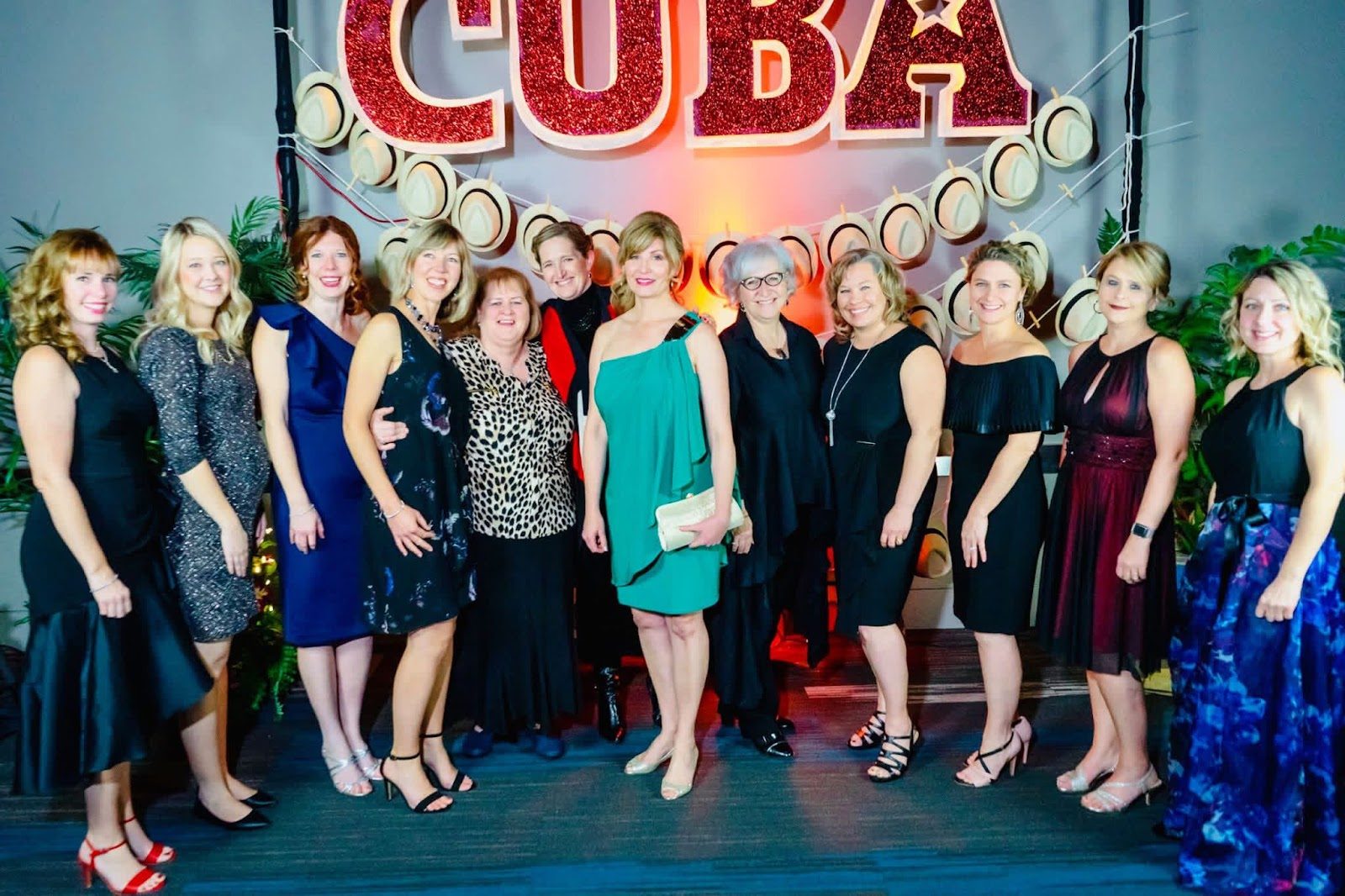 Laura with the PCL ladies, dressed up in front of a CUBA sign