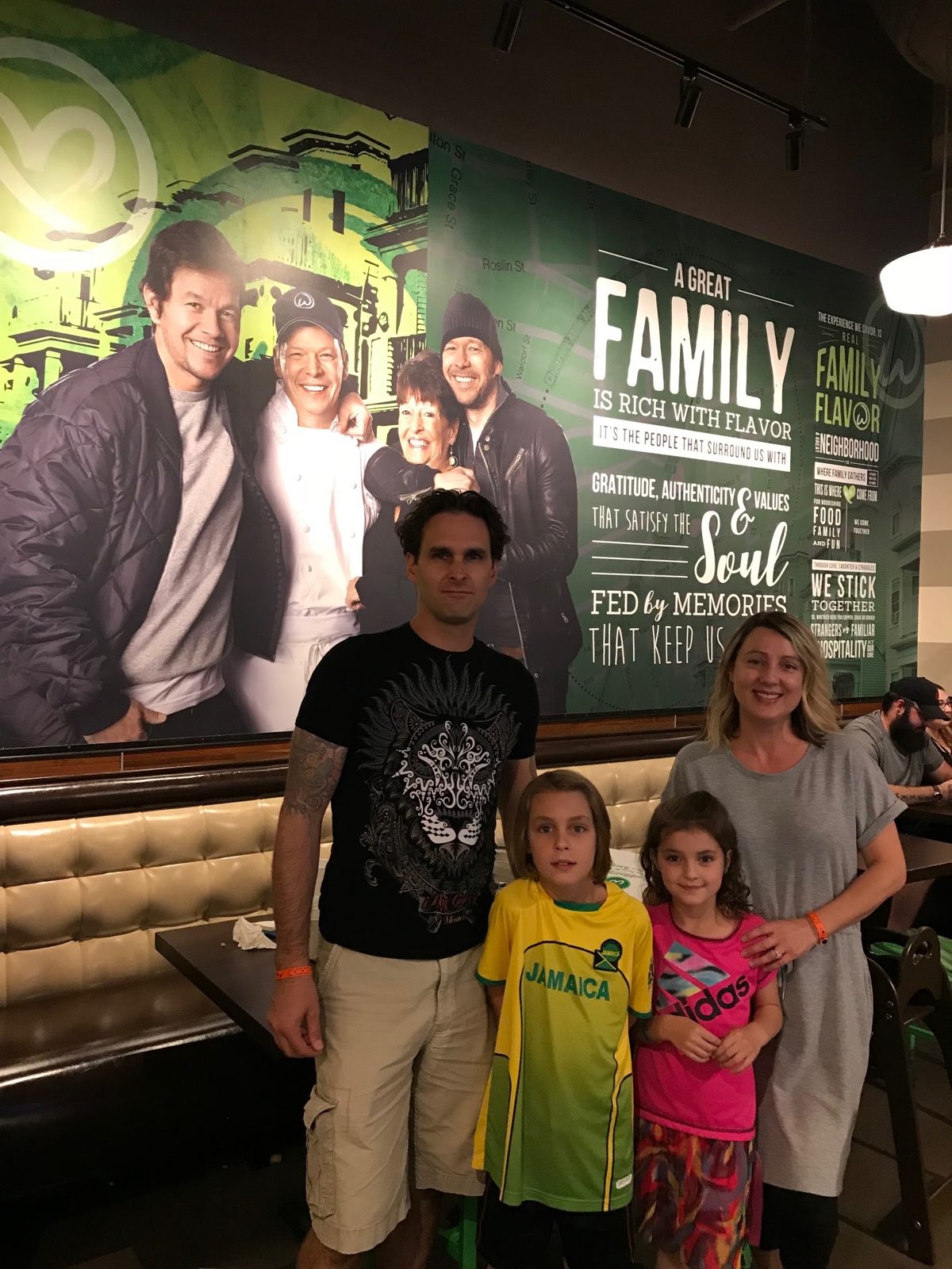 Laura with her family at a restaurant